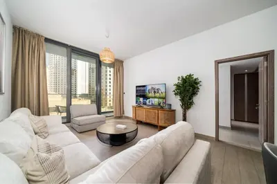 a living room with a couch and a table at Waterfront Living Bright 1 Bedroom Marina in Dubai
