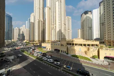 a city with tall buildings and a street with cars at Waterfront Living Bright 1 Bedroom Marina in Dubai