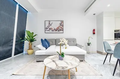 a living room with a couch and a table at Deluxe 1BR Business Bay - with Canal and Skyline Views in Dubai