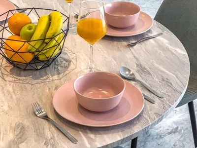 a table with a bowl of fruit and a glass of orange juice at Deluxe 1BR Business Bay - with Canal and Skyline Views in Dubai