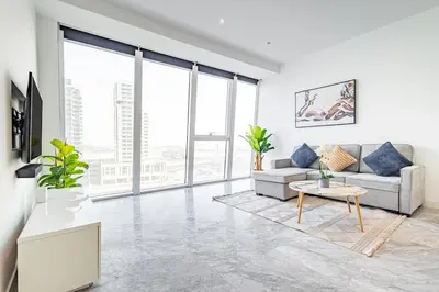 a living room with a couch and a table at Deluxe 1BR Business Bay - with Canal and Skyline Views in Dubai