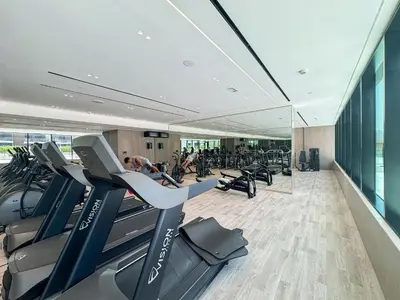 a gym with treadmills and cardio equipment in a building at Modern 1BR Urban Escape at Blue Paradise in Dubai