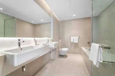 a bathroom with two sinks and a toilet and a shower at 2BR with M CF7B Partial Canal View in Dubai
