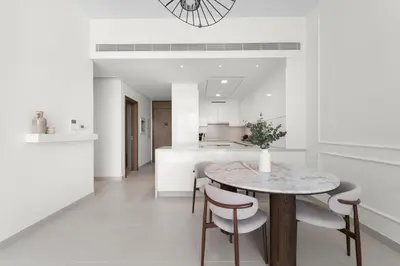 a kitchen and dining room with a table and chairs at 2BR with M CF7B Partial Canal View in Dubai