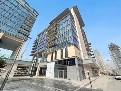 a tall building on the corner of a street at 2BR with M CF7B Partial Canal View in Dubai