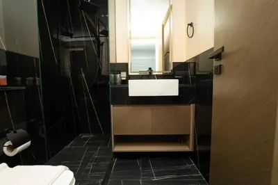 a bathroom with a sink and a mirror at AWS Holiday Homes - Iconic Burj Khalifa Views in Dubai