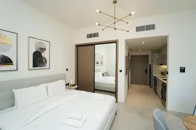 a bedroom with a white bed and a bathroom at AWS Holiday Homes - Iconic Burj Khalifa Views in Dubai