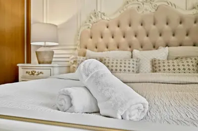 a bed with two rolled towels on it at Private Beach , Luxury 2BR , Emaar 5-Star Amenities in Dubai