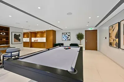 a billiard room with a pool table in it at Private Beach , Luxury 2BR , Emaar 5-Star Amenities in Dubai