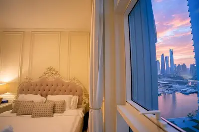 a bedroom with a bed with a view of a city at Private Beach , Luxury 2BR , Emaar 5-Star Amenities in Dubai