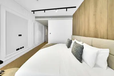 a bedroom with a large white bed with pillows at Exclusive 2BD in JBR Address with Ain Dubai View in Dubai