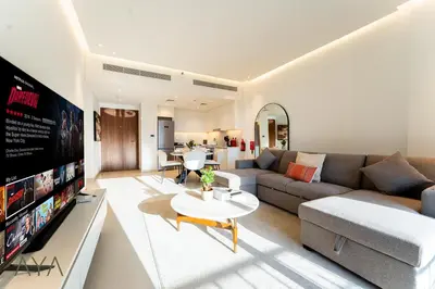 a living room with a couch and a tv at Chic 1BR Apartment near Madinat Jumeirah BurjAlArab in Dubai