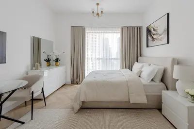 a white bedroom with a bed and a desk at Spacious and luxurious studio with amazing marina view!Rimal ! in Dubai