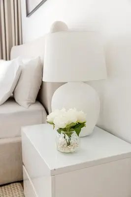 a vase of flowers on a table next to a couch at Spacious and luxurious studio with amazing marina view!Rimal ! in Dubai