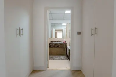 a hallway with a bathroom with a sink and a mirror at Spacious and luxurious studio with amazing marina view!Rimal ! in Dubai