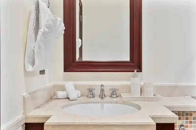 a bathroom with a sink and a mirror at 2BHK Downtown Breathtaking Burj Khalifa View in Dubai