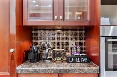 a kitchen counter with a coffee bar on it at 2BHK Downtown Breathtaking Burj Khalifa View in Dubai