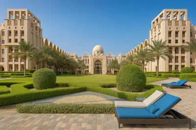 a view of a building with palm trees and a blue chair at The Rosewood HH at Sarai Residence, Palm Jumeirah, 5 mins from the Iconic Atlantis The Royale in Dubai