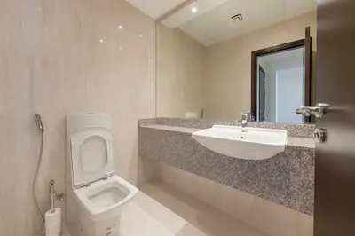 a bathroom with a sink and a toilet at The Rosewood HH at Sarai Residence, Palm Jumeirah, 5 mins from the Iconic Atlantis The Royale in Dubai