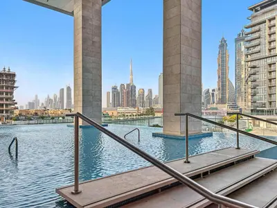 a bridge over a body of water with a city at 2BR with M CF7B Pet Friendly Stay in Dubai