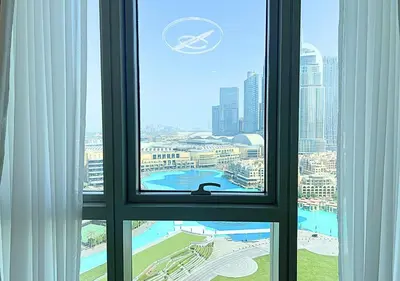 a window view of a city from a hotel room at DreamShoma Grande Signature Luxury Full Burj Khalifa & Fountain View in Dubai