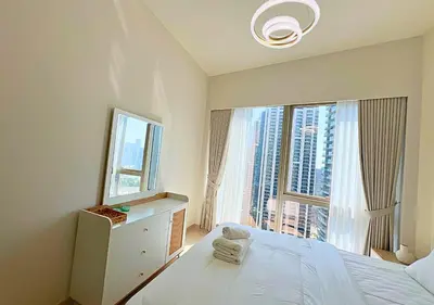 a bedroom with a bed and a large window at DreamShoma Grande Signature Luxury Full Burj Khalifa & Fountain View in Dubai