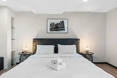 a bedroom with a bed with two towels on it at Duplex 2BR next to Marina Beach in Dubai