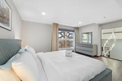 a bedroom with a large white bed and a window at Duplex 2BR next to Marina Beach in Dubai