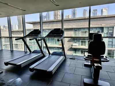 a gym with treadmills in front of a large window at City Walk Building 16, Al Wasl, Jumeirah - Mint Stay in Dubai