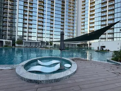 a large swimming pool in a large building at Elegant 1-Bedroom The Crest, Near Downtown Dubai in Dubai