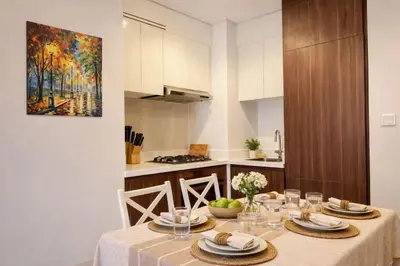 a dining room with a table in a kitchen at Family Stay in Downtown 2BR Sleeps 6 Burj View in Dubai