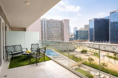 a balcony with a table and chairs and a view of a city at Family Stay in Downtown 2BR Sleeps 6 Burj View in Dubai