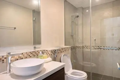 a bathroom with a sink and a toilet and a shower at Family Stay in Downtown 2BR Sleeps 6 Burj View in Dubai