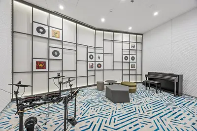a room with a piano and a floor with blue and white carpet at Luxury 1BR Apt at LIV Marina with Direct Marina Views in Dubai