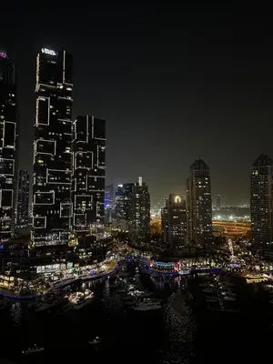 a night view of a city with tall buildings at Luxury 1BR Apt at LIV Marina with Direct Marina Views in Dubai