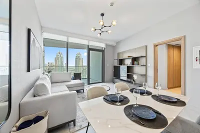 a living room with a couch and a table and chairs at Luxury 1BR Apt at LIV Marina with Direct Marina Views in Dubai