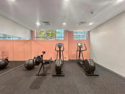 a gym with several exercise equipment in a room at FIRST CLASS 1BR Central Dubai Luxury Living in Dubai