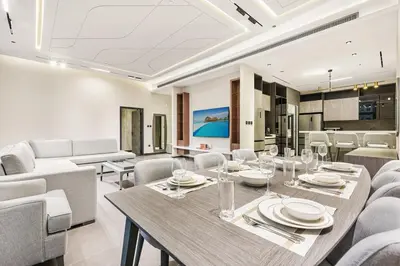 a dining room with a table and chairs at FIRST CLASS 3BR Elegant Comfort , Lake Views in Dubai