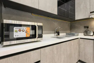 a kitchen with a microwave and a sink at FIRST CLASS 3BR Elegant Comfort , Lake Views in Dubai