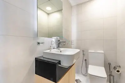 a bathroom with a sink and a toilet at Spacious Balcony with Breathtaking Creek Views, Just a Short Drive from Zabeel Stadium, Al Jaddaf Walk, and Cactus Park, Binghatti Avenue, Al Jaddaf by Deluxe Holiday Homes in Dubai