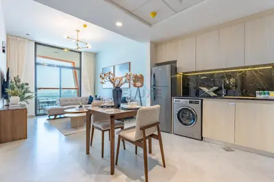 a kitchen and living room with a table and a dishwasher at Spacious Balcony with Breathtaking Creek Views, Just a Short Drive from Zabeel Stadium, Al Jaddaf Walk, and Cactus Park, Binghatti Avenue, Al Jaddaf by Deluxe Holiday Homes in Dubai
