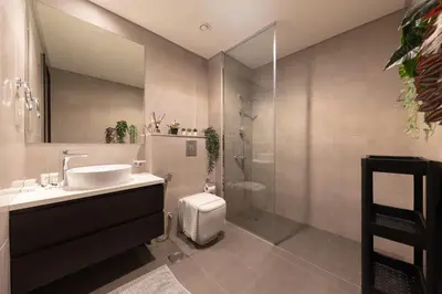 a bathroom with a shower and a sink and a toilet at Modern 2BR Apartment in Merano Tower, Business Bay in Dubai