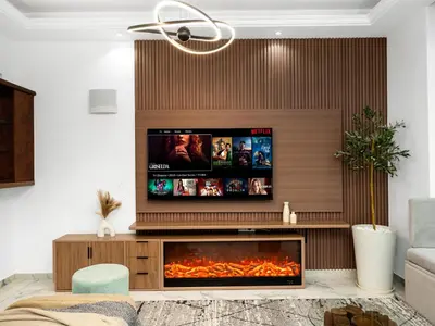 a living room with a tv above a fireplace at Centric Flat w Marina View, Ideal Beach Stay Big Terrace Sleep 9 in Dubai