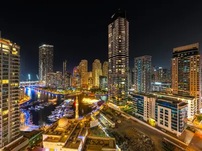 a city skyline at night with tall buildings at Centric Flat w Marina View, Ideal Beach Stay Big Terrace Sleep 9 in Dubai