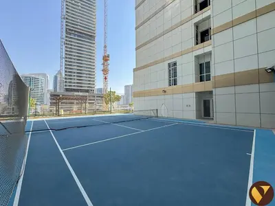 a tennis court in front of a building at Vogue Downtown Mon Reve near Burj Khalifa and Dubai Mall, Two Bedroom plus kids room Apartment with Balcony and Access to all Amenities in Dubai