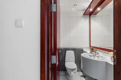 a bathroom with a toilet and a sink and a mirror at Cozy 1BR with gym & pool in heart of Marina - Opal Tower in Dubai