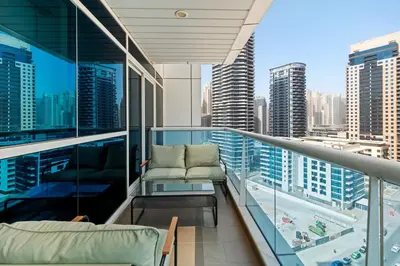 a balcony with a view of a city skyline at Cozy 1BR with gym & pool in heart of Marina - Opal Tower in Dubai