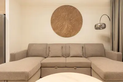 a living room with a couch and a plate on the wall at Spacious 2BR with Burj Khalifa View in Downtown Dubai in Dubai