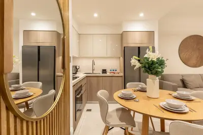 a kitchen and dining room with a table and a mirror at Spacious 2BR with Burj Khalifa View in Downtown Dubai in Dubai