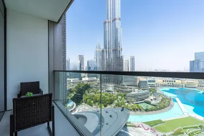 a room with a balcony with a view of a city at 2Bed with spectacular Burj Khalifa & fountain view in Dubai